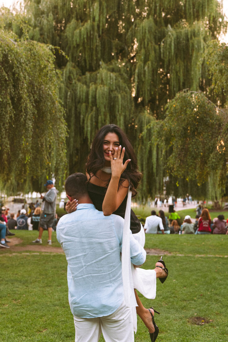 Mehrnaz laughing and showing her ring in a park